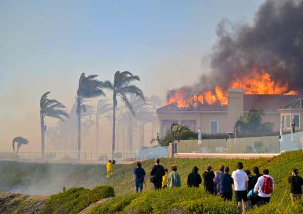 A home burns on Coronado Pointe during the Coastal Fire...