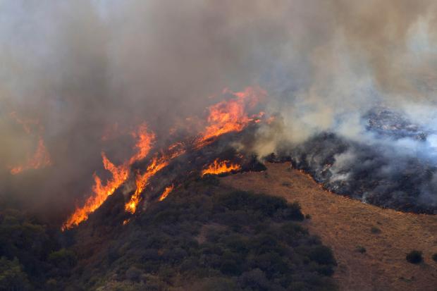 Firefighters battle a brush fire in Laguna Niguel. (Photo by...