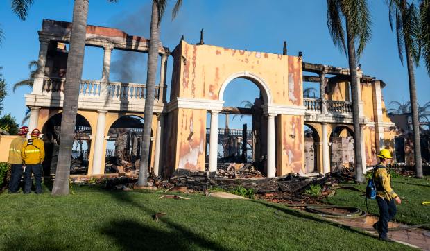 Firefighters monitor hot spots on Coronado Pointe after the Coastal...