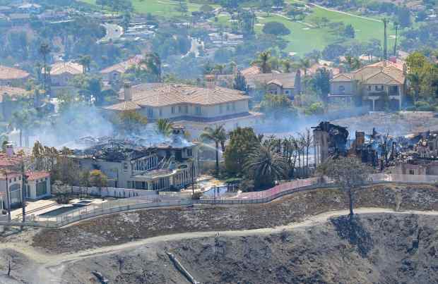 Home are destroyed after the Coastal Fire moved through Laguna...