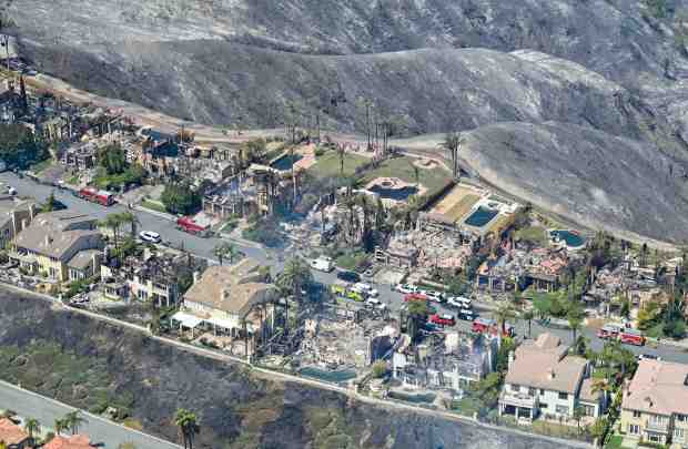Home are destroyed after the Coastal Fire moved through Laguna...