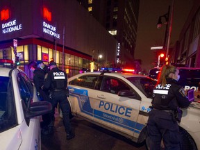 Police detain a man who ran from them at the start of a curfew in Quebec in Montreal on Friday, Dec. 31, 2021.