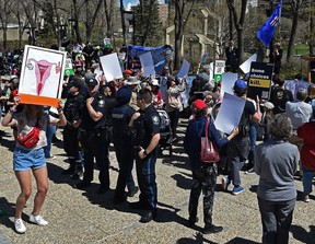 Sheriffs try to keep the pro-choice and pro-life supporters apart at a pro-life rally drawing an estimated 200 supporters to the Alberta legislature in Edmonton, Thursday, May 12, 2022.