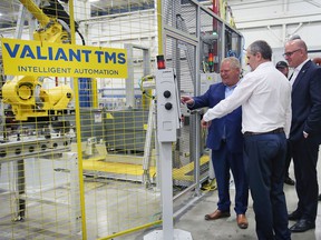 Premier Doug Ford, left, Sladjan Milidrag, Vice President of Global Powertrain Operations at Valiant TMS and Windsor Mayor Drew Dilkens checked out a robotics units prior to a press conference on Friday, May 13, 2022 in Windsor.