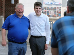 Premier Doug Ford, left, poses with Andrew Dowie, Progressive Conservative candidate for the riding of Windsor-Tecumseh at a photo op in Tecumseh on Thursday, May 12, 2022.