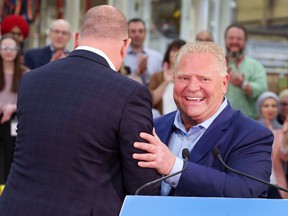Windsor Mayor Drew Dilkens, left, and Premier Doug Ford are shown at a press conference on Friday, May 13, 2022 at the Valiant TMS facility in Windsor.
