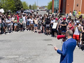 Jason Dupuis, superintendent of education for the French Catholic School Board, speaks to students at Béatrice-Desloges Catholic Secondary School on Friday, as they protest the dress code.