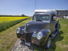 A vintage pickup truck sits parked outside of Scoop Ice Cream and Priscilla's Presents on Iler Road in Harrow, where a 35 acre field of canola is currently in.  Bloom, on Friday, May 13, 2022.