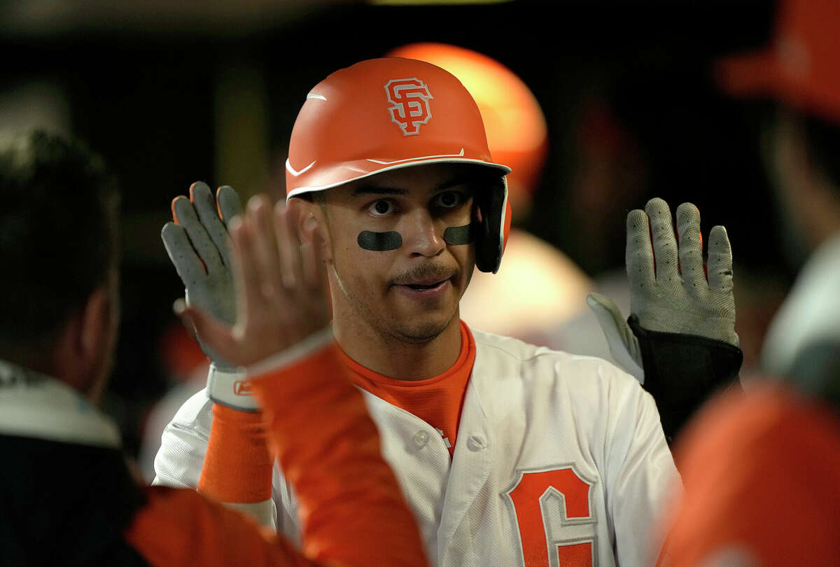 SAN FRANCISCO, CALIFORNIA - MAY 10: Mauricio Dubon #1 of the San Francisco Giants is congratulated by his teammates after scoring against the Colorado Rockies in the bottom of the fifth inning at Oracle Park on May 10, 2022 in San francisco California.  (Photo by Thearon W. Henderson/Getty Images)