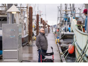 Barney Williams on the wharf at Campbell River looking at the Western King, a fishing vessel he once worked on.