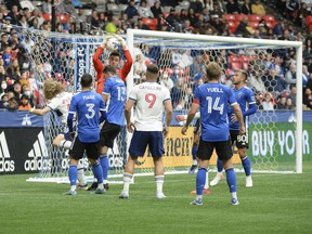 San Jose Earthquakes goalkeeper JT Marcinkowski (1) jumps to stop a corner kick from the Vancouver Whitecaps during the first half at BC Place.