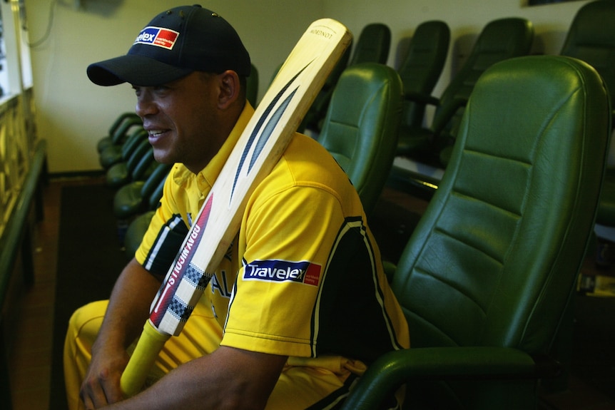 Andrew Symonds, wearing his ODI gear, is all smiles as he sits and holds his bat.