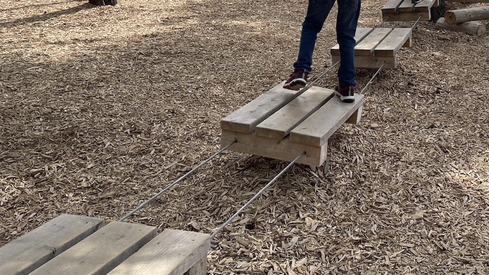 A child is having fun on the obstacle course.