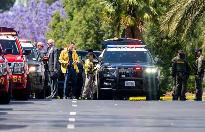 Laguna Woods, CA - May 15: Orange Sheriff's Deputies and investigators ;gather on Sonora Street after one person was killed and four people were in critical condition #x20;injured in a shooting at Geneva Presbyterian Church in Laguna Woods ; on Sunday May 15, 2022.