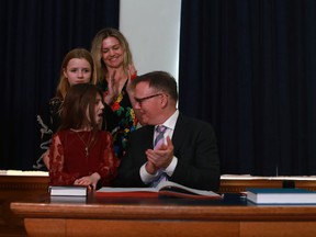 Opposition BC Liberal Party Leader Kevin Falcon shares a moment with his daughters Rose, 9, Josephine, 12, and his wife, Jessica, after being sworn in inside the Hall of Honor at legislature in Victoria, Monday, May 16, 2022.