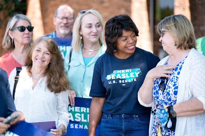 North Carolina Democratic Senate candidate Cheri Beasley, second from right, visits with voters outside a polling location on May 17, 2022 in Troy, North Carolina. North Carolina is one of several states holding midterm primary elections. 