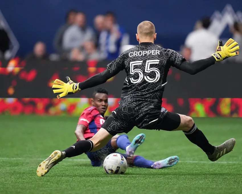 Vancouver Whitecaps goalie Cody Cropper (55) stops FC Dallas' Jader Obrian during the first half of an MLS soccer game in Vancouver, Wednesday, May 18, 2022.