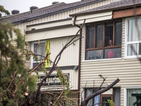 The Stittsville area and many other parts of the Ottawa region were hit by a powerful storm on Saturday, May 21, 2022.  A person peers out the window looking at the large amount of damage at a residence on Carleton Cathcart Street.