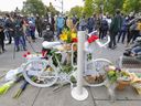 People fill the street for a ghost bike event on Oct. 3, 2021, at the intersection of Parc and Mont Royal avenues in memory of cyclist Andrea Rovere, who was killed at the intersection.