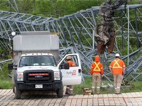 OTTAWA - May 24 2022 -  Hydro One works on some damaged and toppled towers near Hunt Club Road in Ottawa Tuesday. Several towers were knocked down during last Saturdays storm.  TONY CALDWELL, Postmedia.
