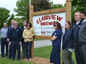 Windsor Mayor Drew Dilkens, second from left, is joined by Motor City Community Credit Union staff, including chief executive Rob Griffith, second from right, and city staff beside new signage on the Clairview Bikeway Trail along Riverside Drive East, Wednesday, May 25, 2022.