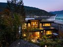 With multiple roof tiers, this 3,200-square-foot waterfront home in Deep Cove features more than 1,000 square feet of decks and patios.  Curvilinear planters offer the temperature-controlling benefits of a green roof, while resembling the owner's favorite golf green in California. 
