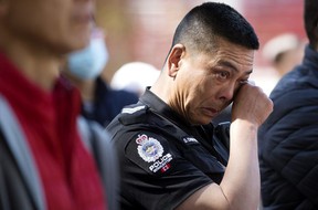 EPS Sgt. David Chow wipes away tears as he attends a Chinatown safety rally outside City Hall, in Edmonton Saturday, May 28, 2022. David Bloom-Postmedia