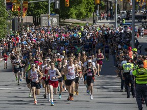 The first group of runners runs up Elgin Street after turning off of Laurier Avenue during the 5K race on Saturday afternoon.