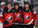 Canada's Cole Sillinger, left, celebrates with Matt Barzal, centre, and Canadiens' Josh Anderson during the IIHF Ice Hockey World Championships semifinal match against Czechia in Tampere, Finland, on Saturday, May 28, 2022. 