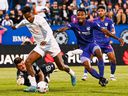 CF Montréal forward Romell Quioto (30) plays the ball against FC Cincinnati goalkeeper Roman Celentano (18) for a goal during the first half at Saputo Stadium on Saturday, May 28, 2022, in Montreal.