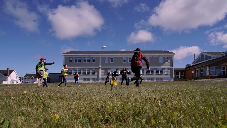 Young people play Frisbee in the courtyard of St-Joseph school.                         