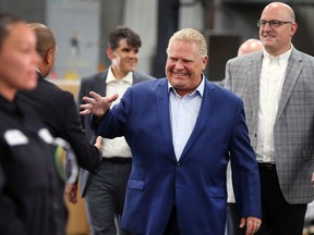 Ontario PC leader Doug Ford shakes hands at a campaign stop Monday, May 30, 2022, at Laval Tool and Mold in Tecumseh.