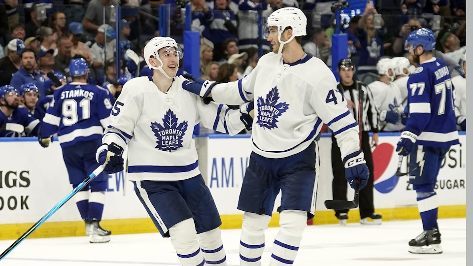 Forwards Ilya Mikheyev and Pierre Engvall celebrate a goal in Maple Leafs uniform.