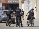 Police patrol Edmonton's Chinatown district on Thursday, May 26, 2022, after two recent random homicides in the area.
