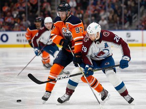 Edmonton Oiler Connor McDavid (left) battles for the puck against Nathan MacKinnon of the Colorado Avalanche during a National Hockey League game in Edmonton last month.