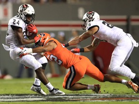 Zonovan Knight of the North Carolina State Wolfpack is hit by Tyrell Richards of the Syracuse Orange during a 2019 games in Raleigh, North Carolina.  Richards, from Brampton, was the first overall pick in the 2022 CFL draft on Tuesday night.