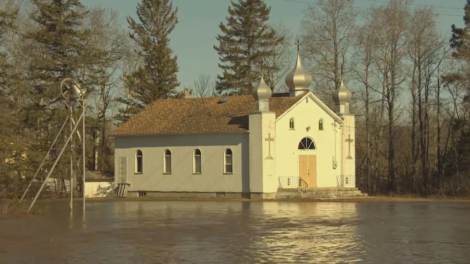 Spring flood waters surround a church in Arborg, Manitoba.