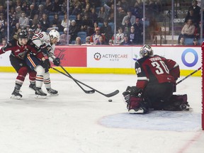 Luke Toporowski of the Kamloops Blazers edges past Vancouver Giants defenseman Connor Horning during the first period of the WHL playoffs Game 1 against at the Sandman Center in Kamloops May 6, 2022.