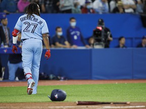 Vladimir Guerrero Jr. of the Toronto Blue Jays walks away from his bat and helmet after striking out.