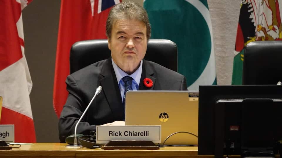 Rick Chiarelli sitting in front of a laptop and a microphone.