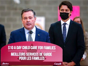 Prime Minister Justin Trudeau, right, looks on as Alberta Premier Jason Kenney makes a childcare announcement in Edmonton on Monday, Nov. 15, 2021.