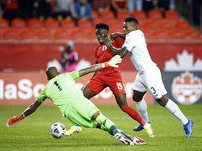 Canadian star Alphonso Davies (centre) works some of his magic, and is the center of attention, against Panama in World Cup qualifying at Toronto's BMO Field last October.