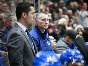 Vancouver Canucks athletic therapist Jon Sanderson (in blue jacket) on the bench at Rogers Arena.  Sanderson, who dismissed by the Canucks on Friday, celebrated his 1500th game in the NHL on Dec. 19, 2019.