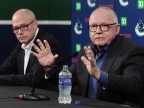 Canucks president of hockey operations Jim Rutherford, with general manager Patrik Allvin (left) in tow, talks to Vancouver media on Tuesday.  'We would be willing to have him back under the contract that he agreed to when he came here,' Rutherford said of coach Bruce Boudreau.
