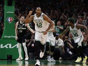 Celtics center Al Horford (42) pumps his fist as he heads back up court after hitting a basket against the Bucks during the second half of Game 7 of the second round of the 2022 NBA playoffs at TD Garden in Boston, May 15, 2022.