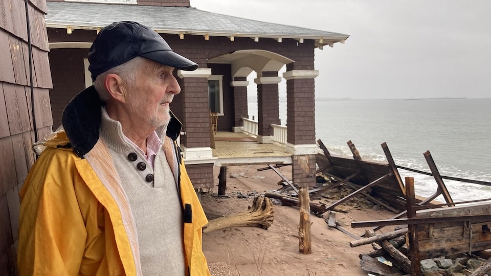 Michel Saint-Pierre stands outside Château Dubuc, facing the sea that threatens the building.