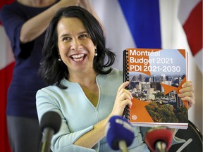 Montreal Mayor Valérie Plante holds up a copy of the city's budget for the coming year at a press conference in Montreal Thursday Nov. 12, 2020.