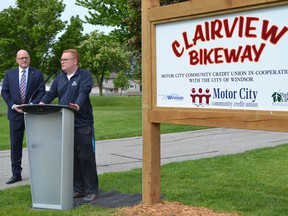 Windsor Mayor Drew Dilkens, left, looks on as Motor City Community Credit Union chief executive Rob Griffith outlines the credit union's five-year financial commitment to improve to the Clairview Bikeway Trail on the city's east side, Wednesday, May 25, 2022.