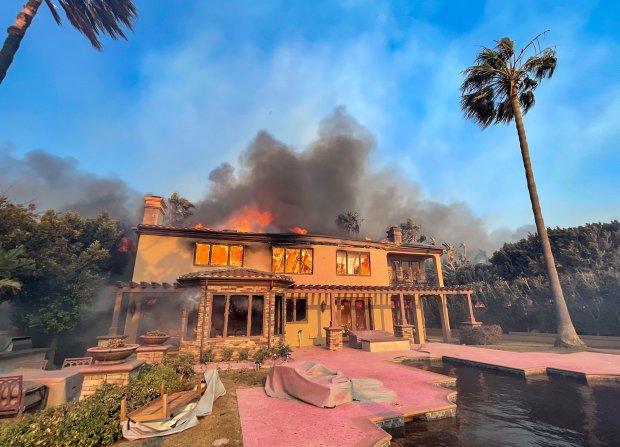 A home burns on Coronado Pointe during the Coastal Fire...