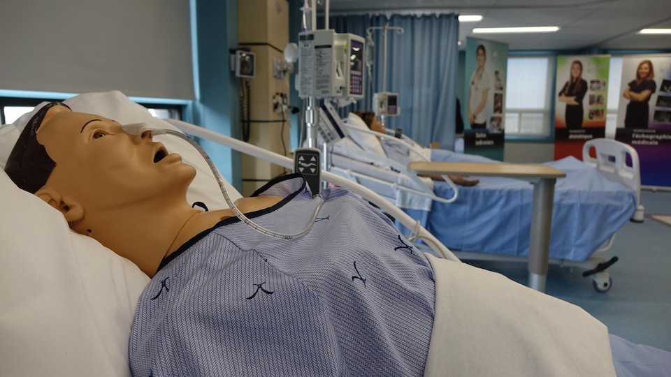 A mannequin on a hospital bed.
